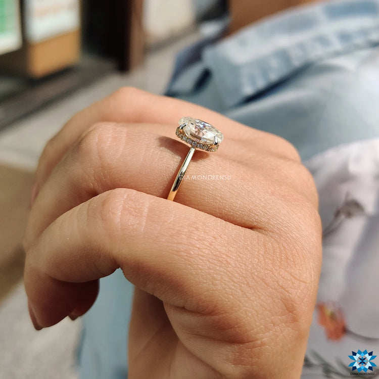 Oval cut moissanite ring with 4-prong setting.