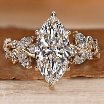 Nature inspired engagement ring with a marquise center stone.