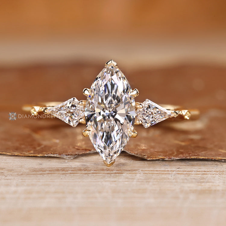 Art Deco diamond ring with marquise center stone and kite side stones.