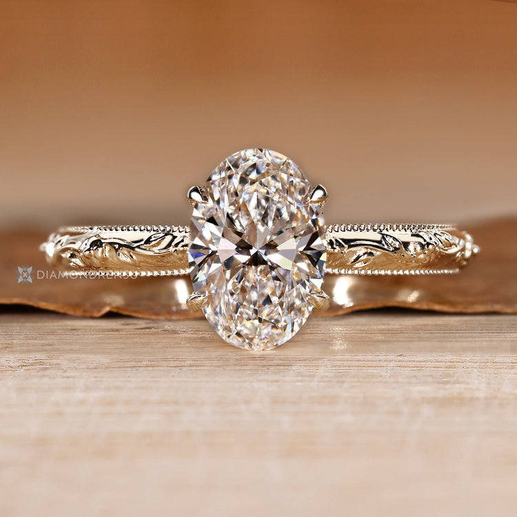 Oval ring with a botanical vine and leaf shank.