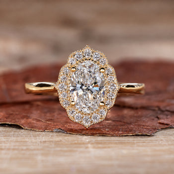 Close-up of a sparkling oval halo engagement ring with a polished silver band