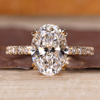 Oval hidden halo engagement ring featuring round cut hidden halo design.
