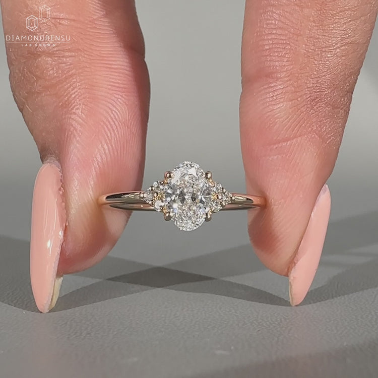 Muse setting ring featuring oval diamond and seven stone arrangement.
