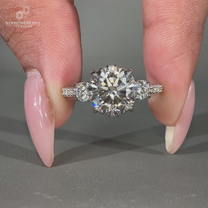 Exquisite 3 stone ring featuring a filigree design and prong setting.