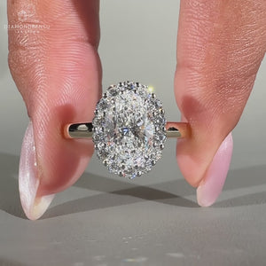 Oval diamond engagement ring featuring a cathedral setting in yellow gold
