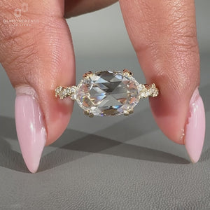 Elegant east west oval ring with a hidden halo, crafted for a unique engagement style.
