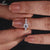 Sparkling round diamond engagement ring on a velvet box, showcasing classic beauty.