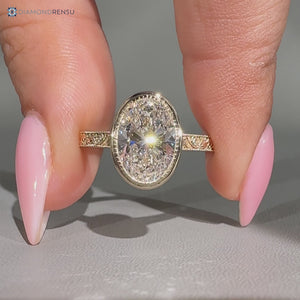 Oval diamond ring with milgrain details and cathedral setting