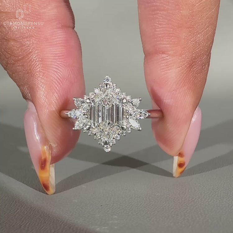 Marquise diamond ring with side stones in white gold.
