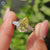 Canary yellow pear cut moissanite ring in cathedral setting.