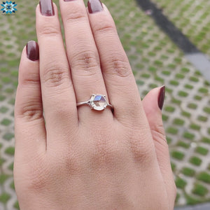 Round rose cut moissanite glowing in a delicate prong setting.
