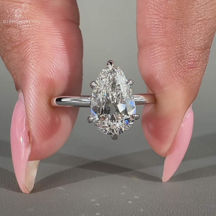 White gold pear engagement ring with 6 claw prong setting.
