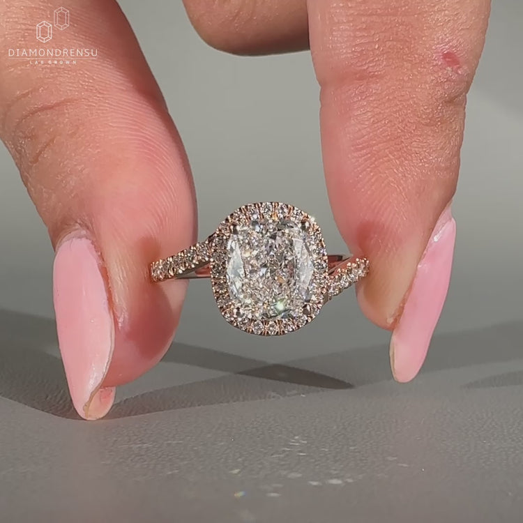 Cushion cut diamond set in a halo design.
