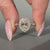 Oval Diamond Ring Surrounded By Round Cut Halo Setting.