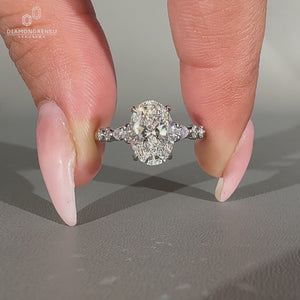 Handmade oval cut diamond ring with cathedral setting and four claw prongs.