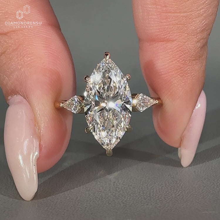 Marquise diamond ring with kite cut side stones.
