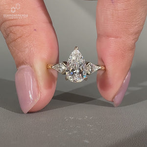 Lab Grown Diamond pear cut engagement ring with kite side stone.
