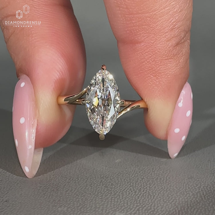Handmade lab grown marquise diamond ring with compass prong design.