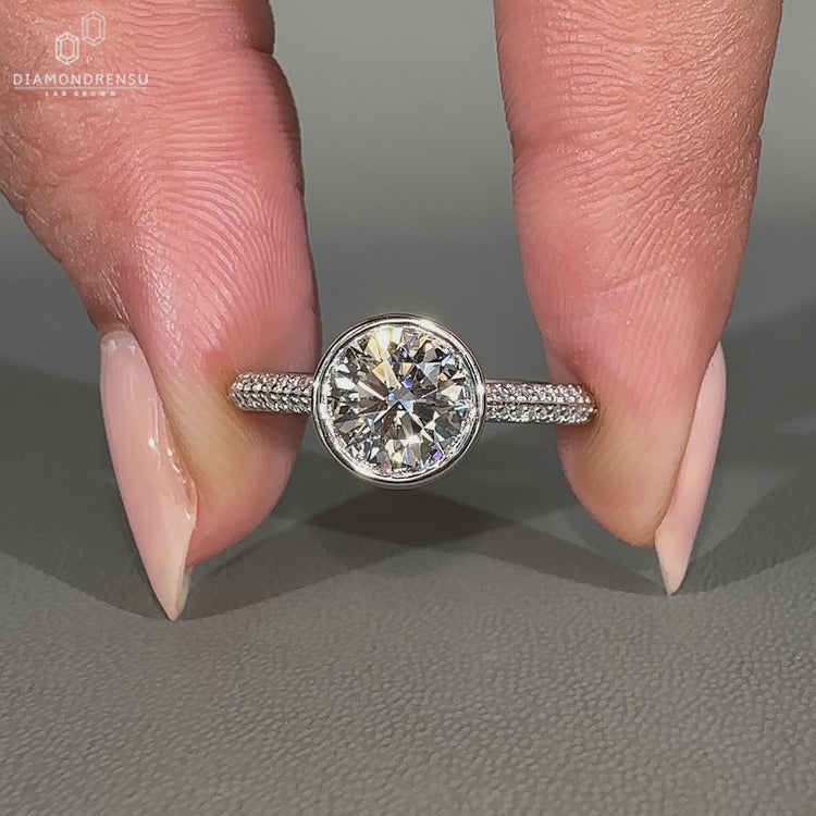 Custom handmade ring with round cut diamond and round cut pave band.