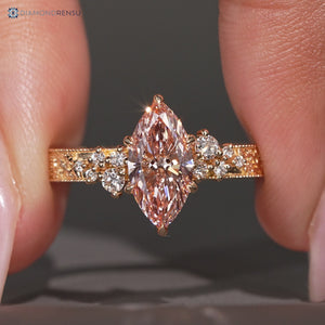 Pink center stone defines this marquise engagement ring.