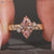 Pink center stone defines this marquise engagement ring.