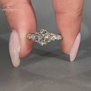 Handmade ring with round old european cut diamond and side stones.