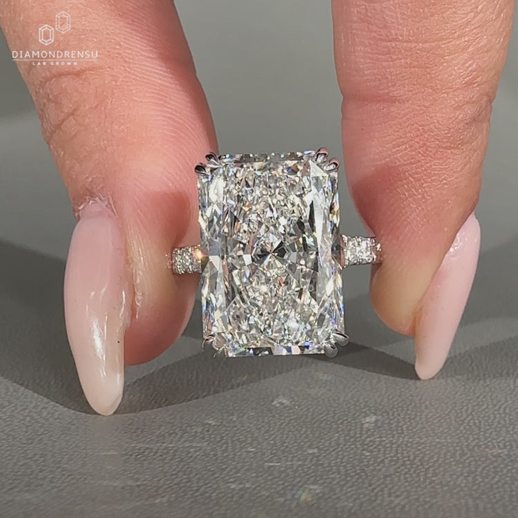 Radiant diamond engagement ring with pave band.
