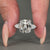 Vintage style diamond ring with cushion old mine center and pear sides.