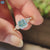 Cyan blue moissanite ring with side stones