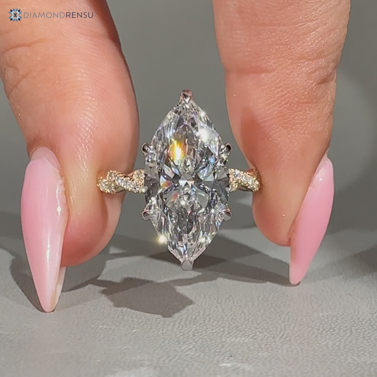 Twisted shank with round accents complements this marquise engagement ring.