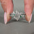 Dutch marquise center stone highlights this diamond band wedding ring.