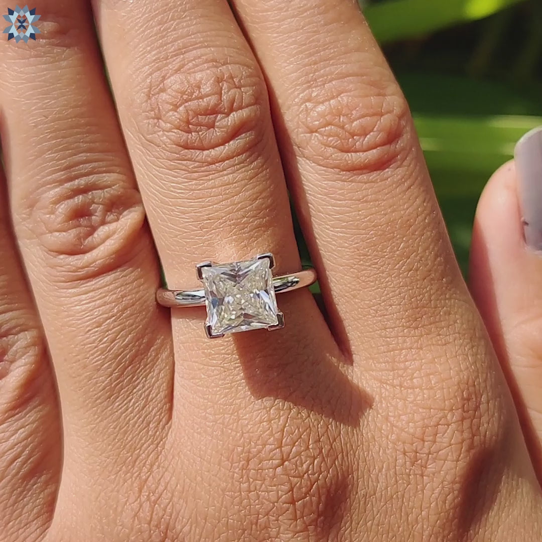 Elegant princess cut ring with a 2 ct moissanite centre stone, crafted in white gold.