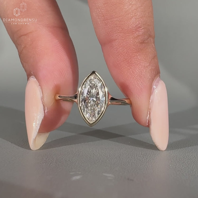 Solitaire engagement ring set in a pinch shank setting.
