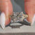 Princess cut Art Deco engagement ring with round side stones.