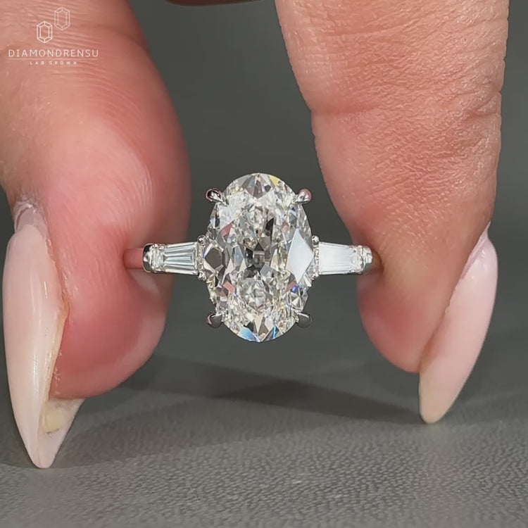 Tapered baguette side stones match the 4 claw prong setting.
