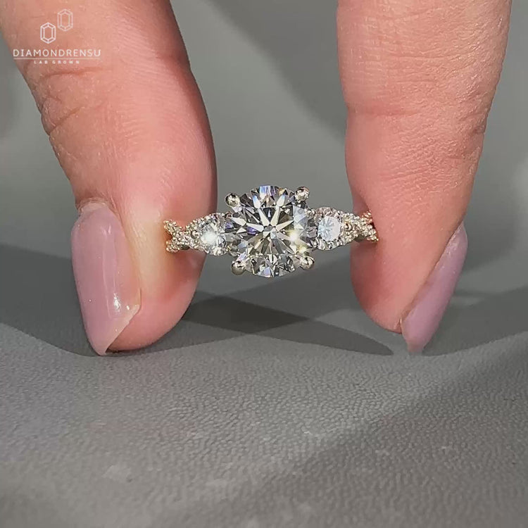 Lab Grown Diamond round cut engagement ring with three stone design.
