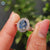 Halo setting ring featuring an Oval Cut Moissanite in a beautiful vintage style.

