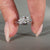 White gold pear diamond ring with V shaped prong and two round prongs.
