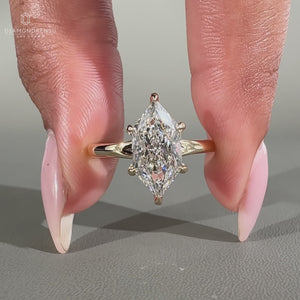 Solitaire setting with marquise diamond in a yellow gold engagement ring with 6 claw prong design.
