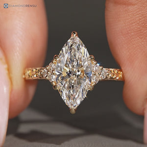 Marquise center stone paired with round side stones and muse setting.