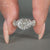 Handmade lab grown diamond ring with a twisted pave band and cathedral setting.