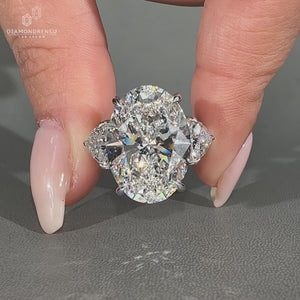 Trillion cut diamond ring with oval center.
