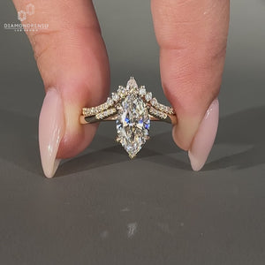 Round cut pave style complements this marquise wedding ring.