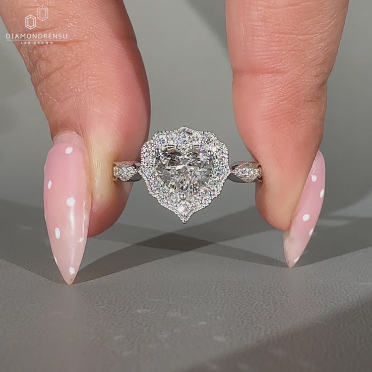 Heart Shape Diamond Ring Surrounded By Round Cut Halo Setting.