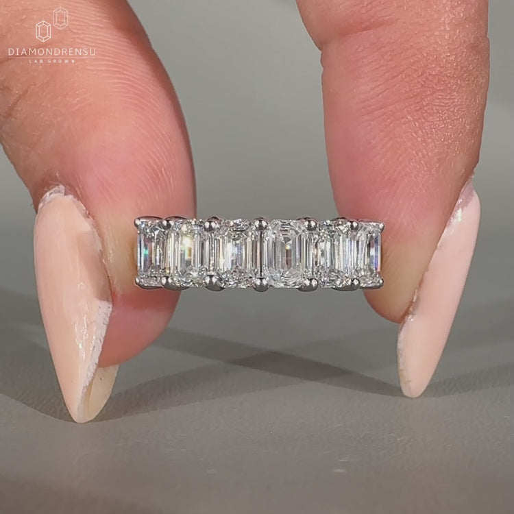 White gold wedding band with 6 stone layout.
