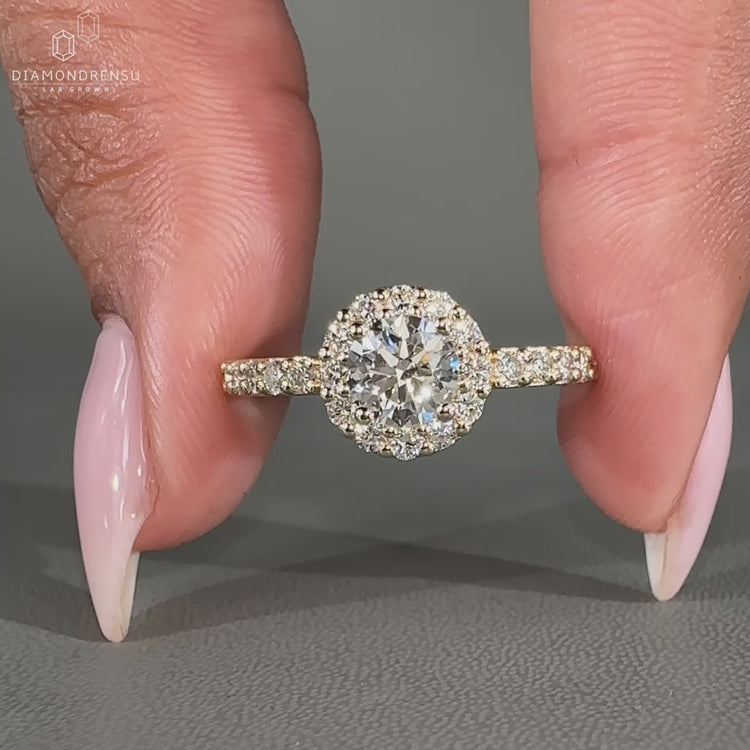 Handmade yellow gold engagement ring with a halo setting.
