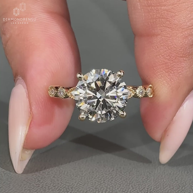 Yellow gold engagement ring with round diamond.
