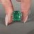 Distance pave engagement ring with emerald center.
