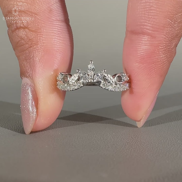 Marquise diamond wedding band with nature-inspired design.
