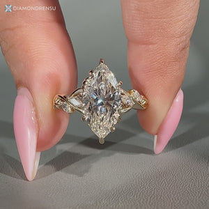 Marquise center stone defines this nature inspired engagement ring.